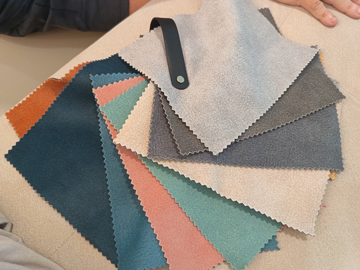 Fan of pet-friendly velvet fabric swatches in greys, blues, greens, beige and terracotta